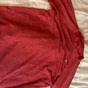 This is a red dri-fit nike shirt in size large.